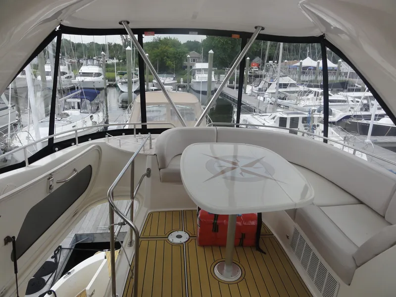 Slide: The Image of 2009 Meridian 441 Sedan yacht interior with seating and table, docked at marina. - 20