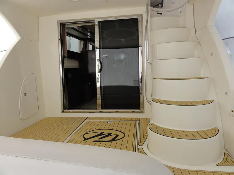 Slide: The Image of 2009 Meridian 441 Sedan yacht interior with spiral staircase and sliding glass door. - 27
