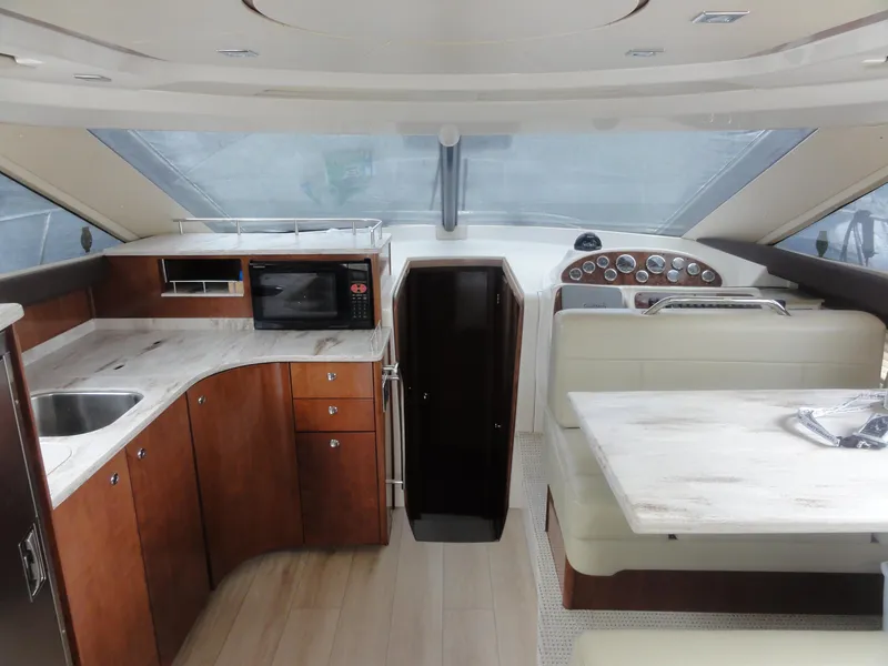 Slide: The Image of Interior of 2009 Meridian 441 Sedan yacht with kitchen and dining area. - 28