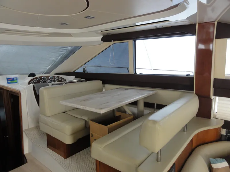 Slide: The Image of Interior of 2009 Meridian 441 Sedan yacht with beige seating and dining table. - 45