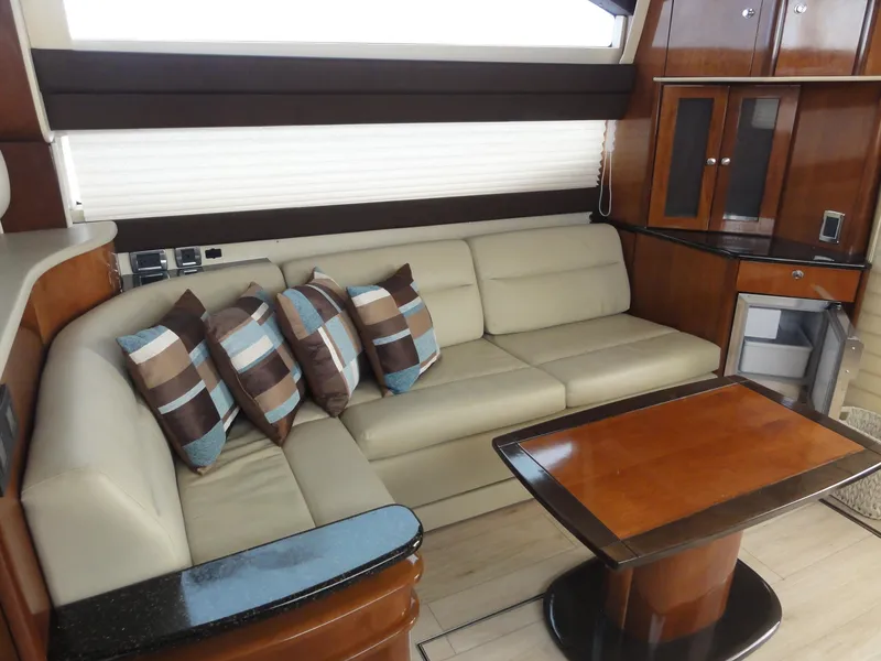 Slide: The Image of Luxurious interior of 2009 Meridian 441 Sedan with beige sofa and wooden table. - 46