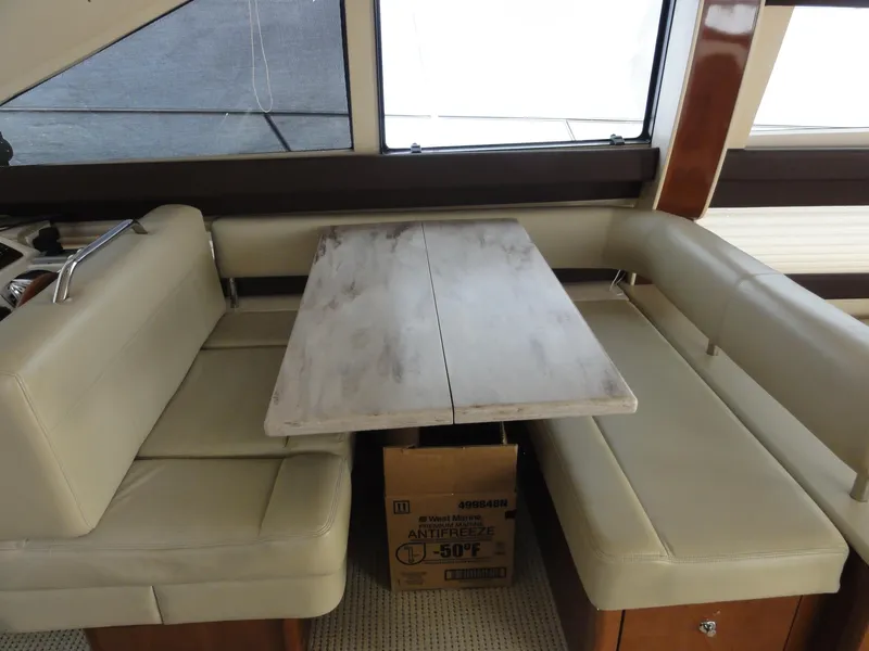 Slide: The Image of Interior of 2009 Meridian 441 Sedan with beige seating and a marble-style table. - 48
