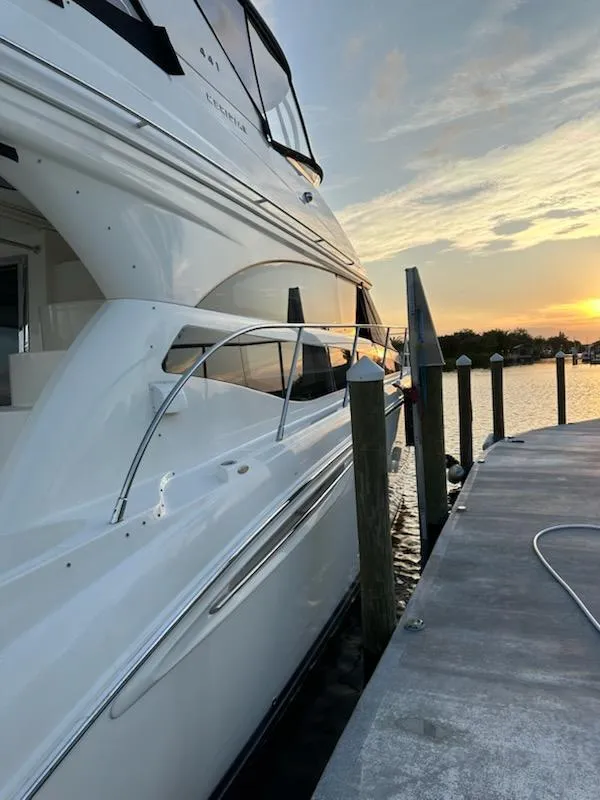 Slide: The Image of 2009 Meridian 441 Sedan yacht docked at sunset, showcasing sleek design and luxury. - 8