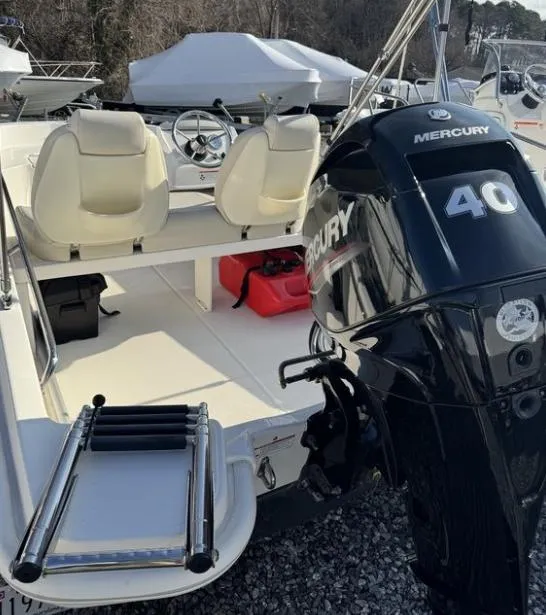 Slide: The Image of 2024 Boston Whaler 130 Super Sport with Mercury 40 engine, docked outdoors. - 18