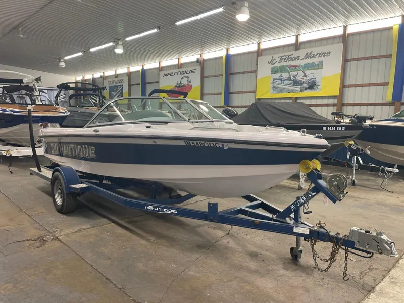 Slide: The Image of 2006 Nautique Ski 206 boat on trailer in indoor showroom. - 1