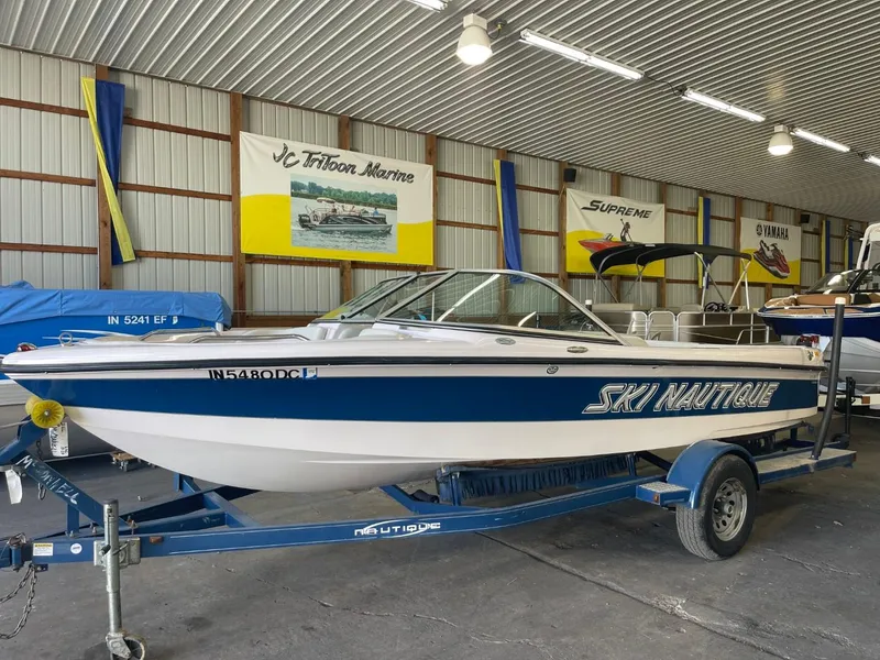 Slide: The Image of 2006 Nautique Ski 206 boat on trailer in indoor storage facility. - 10