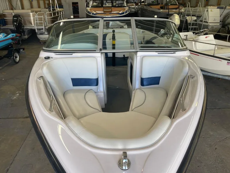Slide: The Image of 2006 Nautique Ski 206 boat with white interior, docked in a storage facility. - 12