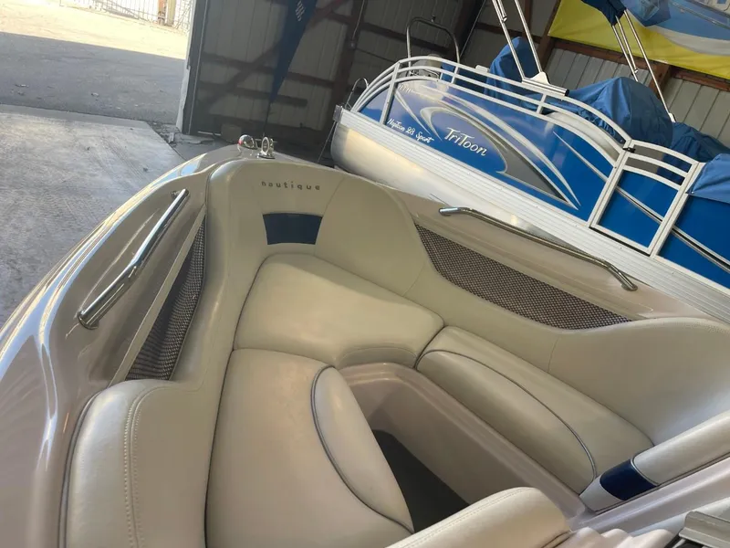 Slide: The Image of 2006 Nautique Ski 206 boat interior with beige seating in a storage area. - 13