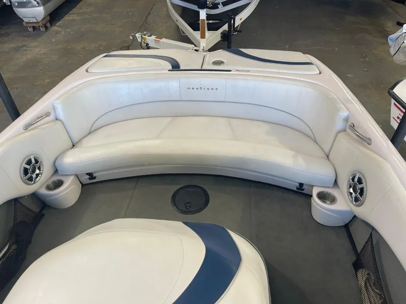 Slide: The Image of 2006 Nautique Ski 206 boat interior with white seating and cup holders. - 16