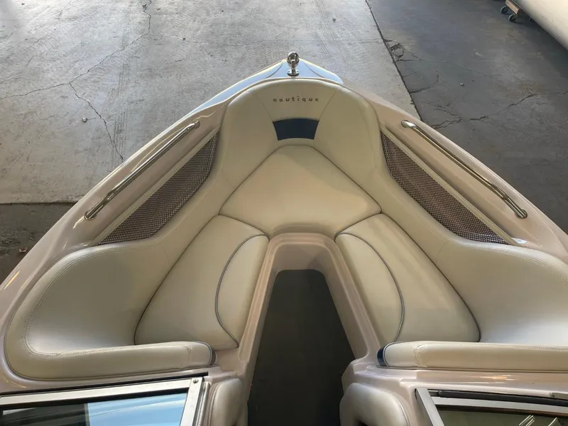 Slide: The Image of 2006 Nautique Ski 206 boat interior with white cushioned seating. - 19