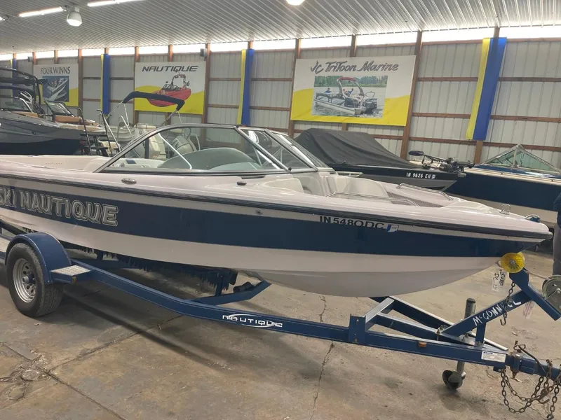 Slide: The Image of 2006 Nautique Ski 206 boat on trailer in indoor storage facility. - 2