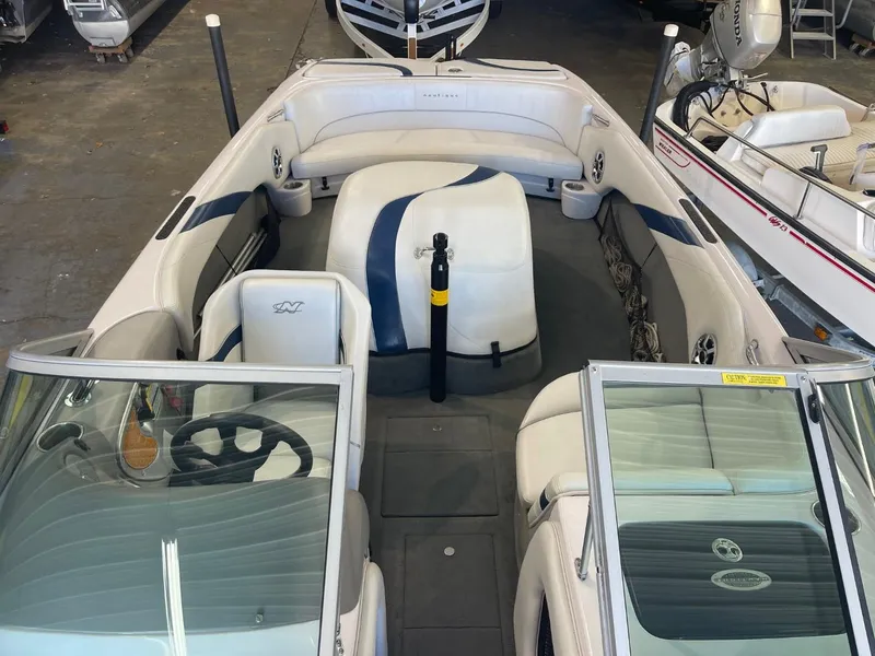 Slide: The Image of 2006 Nautique Ski 206 boat interior with white and blue seating, steering wheel, and open windshield. - 20