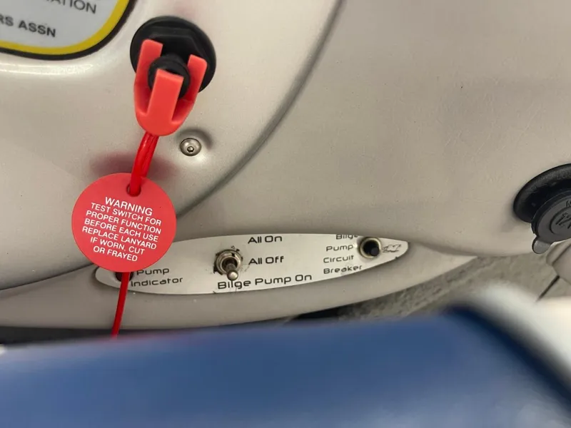 Slide: The Image of Control panel of a 2006 Nautique Ski 206 boat with bilge pump switch. - 24