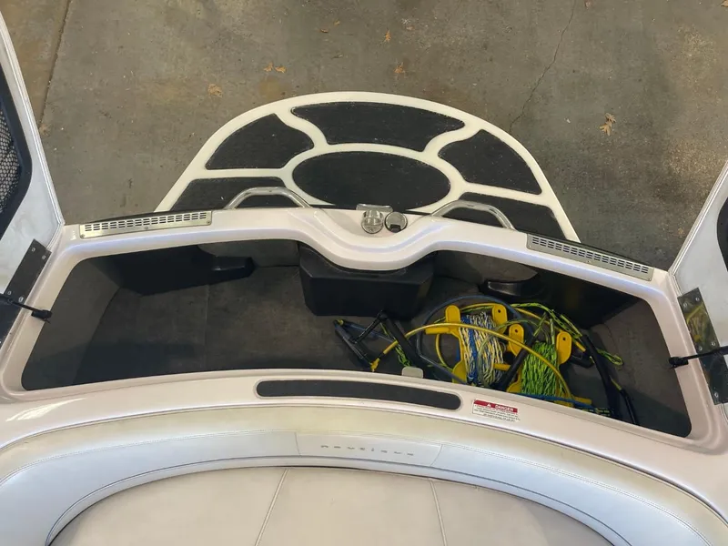 Slide: The Image of 2006 Nautique Ski 206 boat storage compartment with equipment and gear. - 32