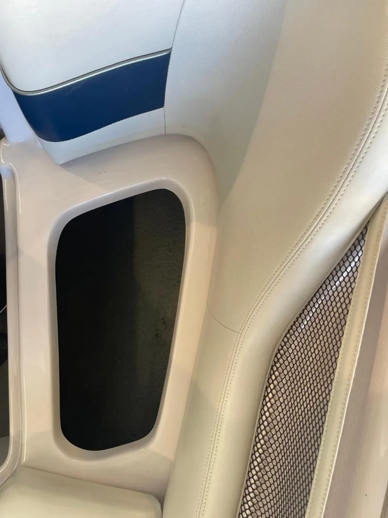 Slide: The Image of 2006 Nautique Ski 206 interior detail with beige upholstery and storage compartment. - 34