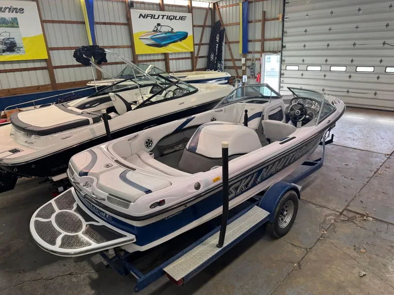 Slide: The Image of 2006 Nautique Ski 206 boat in a showroom, displayed on a trailer. - 40