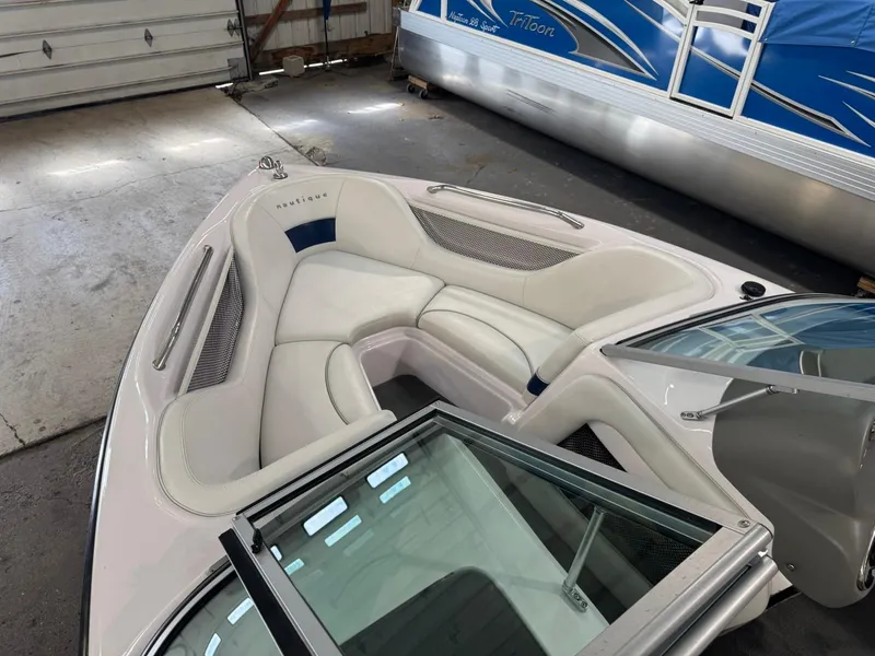 Slide: The Image of 2006 Nautique Ski 206 boat interior with white seating in a garage setting. - 43