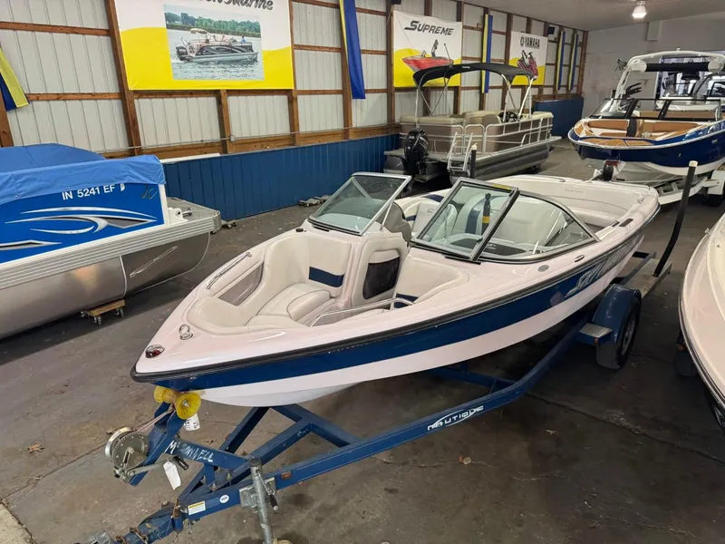 Slide: The Image of 2006 Nautique Ski 206 boat on trailer in showroom. - 46