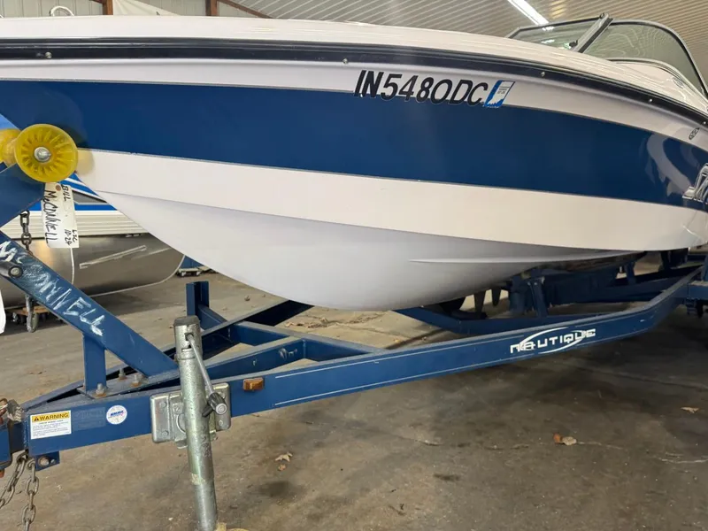 Slide: The Image of 2006 Nautique Ski 206 boat on trailer in storage facility. - 47