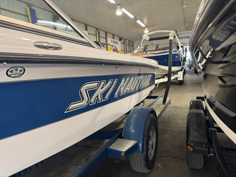 Slide: The Image of 2006 Nautique Ski 206 boat on trailer in indoor storage facility. - 49
