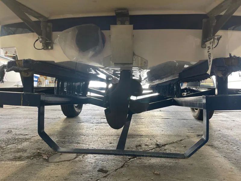 Slide: The Image of 2006 Nautique Ski 206 boat on trailer, viewed from underneath in a garage setting. - 6