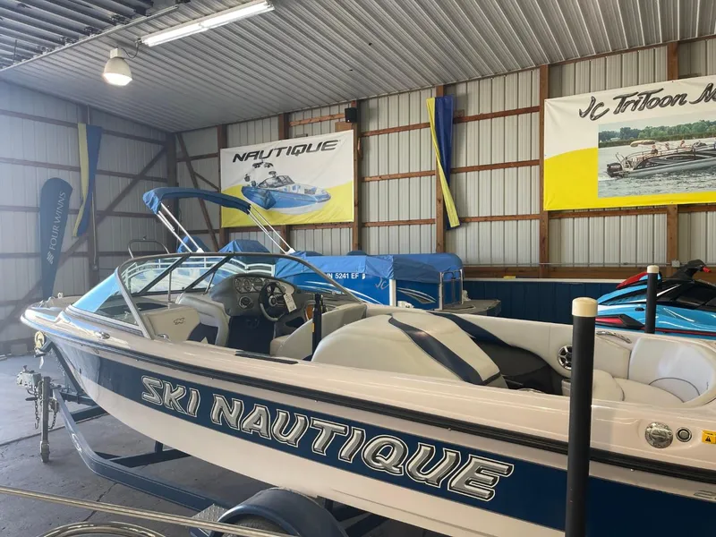 Slide: The Image of 2006 Nautique Ski 206 boat in a storage facility, showcasing sleek design and branding. - 8