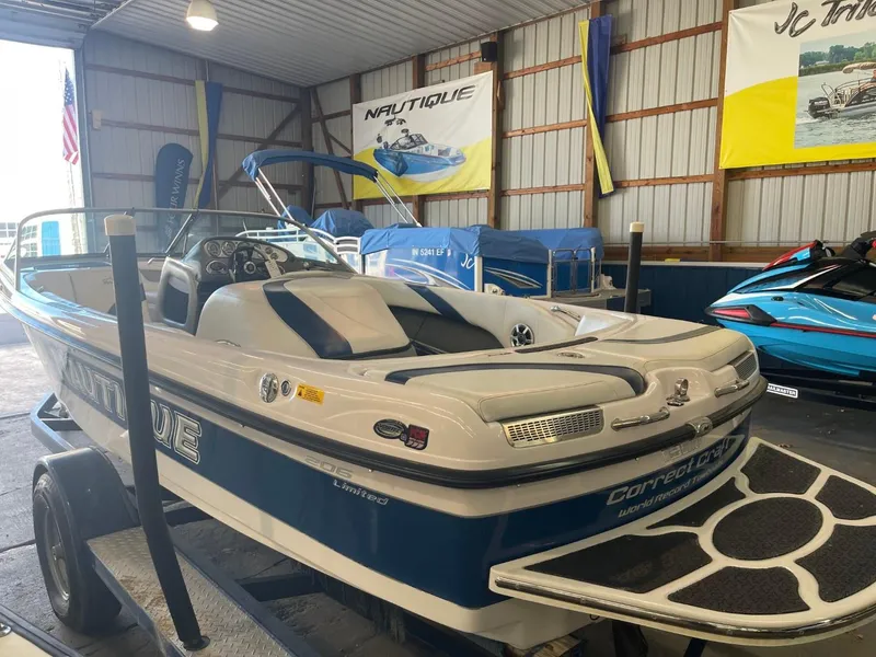 Slide: The Image of 2006 Nautique Ski 206 boat in a showroom, showcasing sleek design and features. - 9