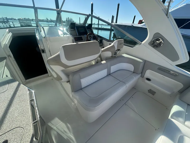 Slide: The Image of 2014 Chaparral 310 Signature Axis boat interior with plush seating and modern helm. - 15