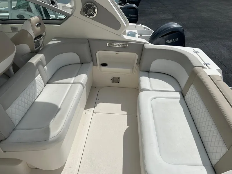 Slide: The Image of 2014 Chaparral 310 Signature boat interior with white and beige seating. - 17