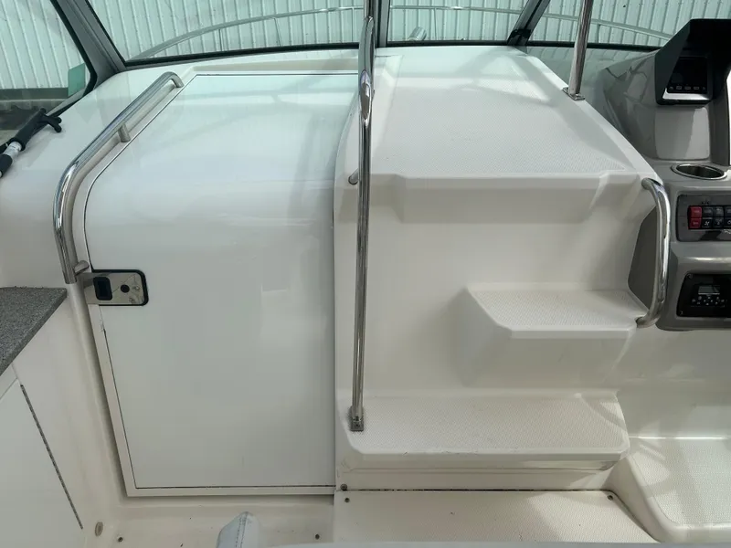 Slide: The Image of 2014 Chaparral 310 Signature boat interior with white steps and railing. - 21
