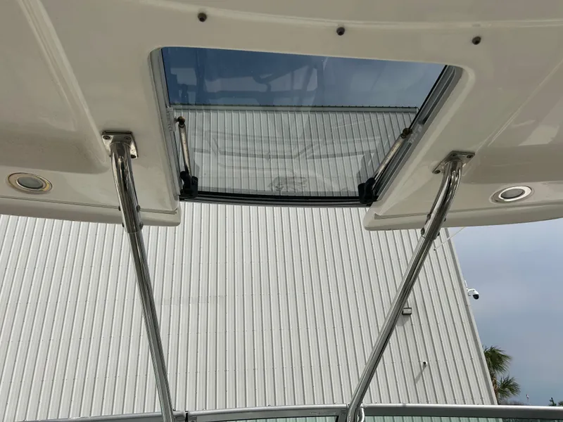 Slide: The Image of 2014 Chaparral 310 Signature Axis boat sunroof, open with metal supports. - 22