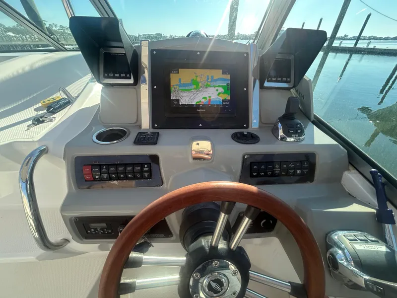 Slide: The Image of Helm of 2014 Chaparral 310 Signature Axis with navigation display and controls. - 24