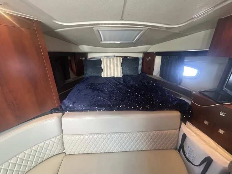 Slide: The Image of Interior cabin of 2014 Chaparral 310 Signature Axis with bed and seating area. - 25