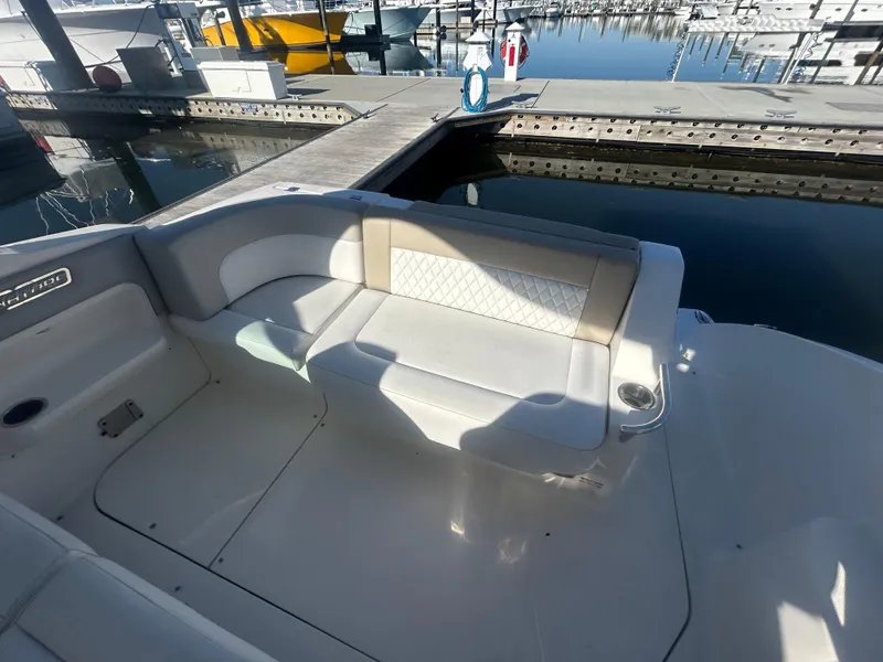 Slide: The Image of 2014 Chaparral 310 Signature boat seating area at marina dock. - 29