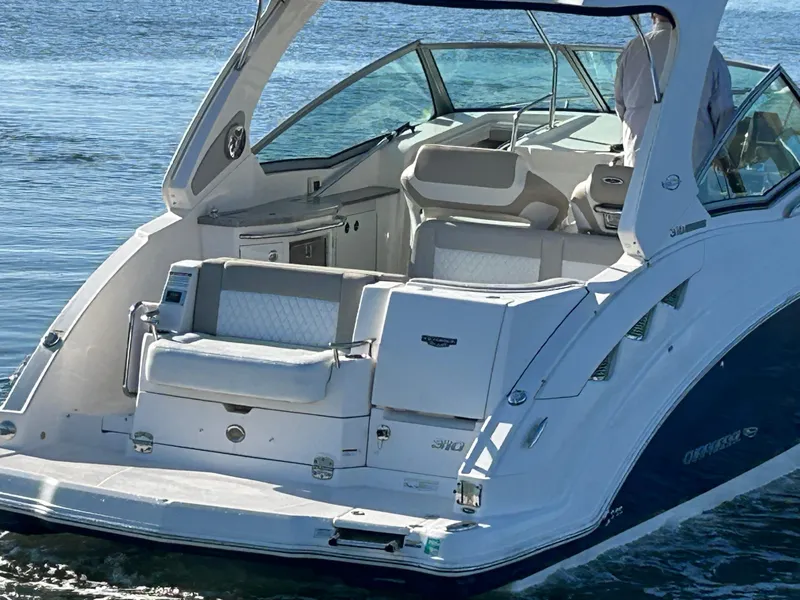 Slide: The Image of 2014 Chaparral 310 Signature Axis boat with spacious seating on calm water. - 3