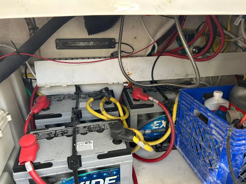 Slide: The Image of Battery compartment of 2014 Chaparral 310 Signature boat with wiring and storage crate. - 38