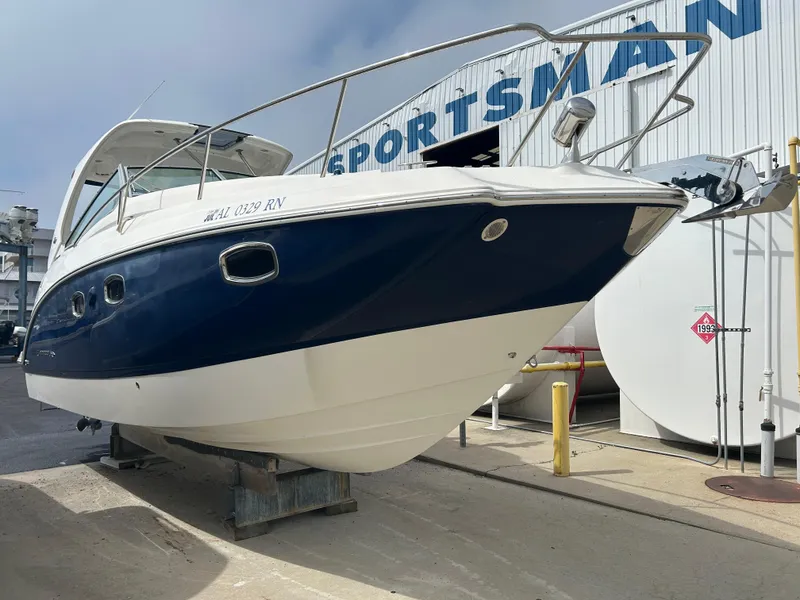 Slide: The Image of 2014 Chaparral 310 Signature Axis boat on display at a marina. - 9