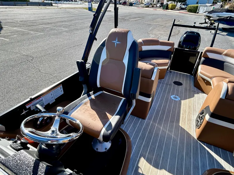 Slide: The Image of 2021 Berkshire 25RFX DC STS 3.0+ pontoon boat interior with brown seating and steering wheel. - 20