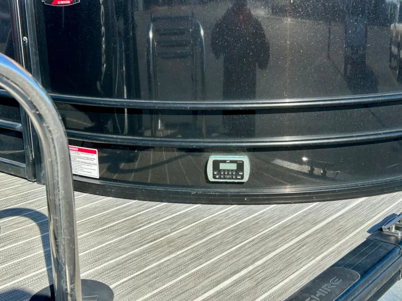 Slide: The Image of 2021 Berkshire 25RFX DC STS 3.0+ boat with black exterior and striped flooring. - 22