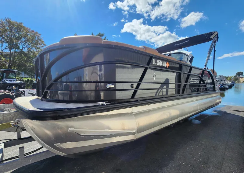 Slide: The Image of 2021 Berkshire 25RFX DC STS 3.0+ pontoon boat on trailer under blue sky. - 3