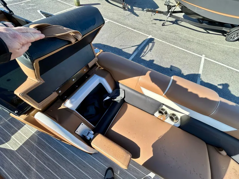 Slide: The Image of 2021 Berkshire 25RFX DC STS 3.0+ boat interior with brown seating and storage compartment. - 9