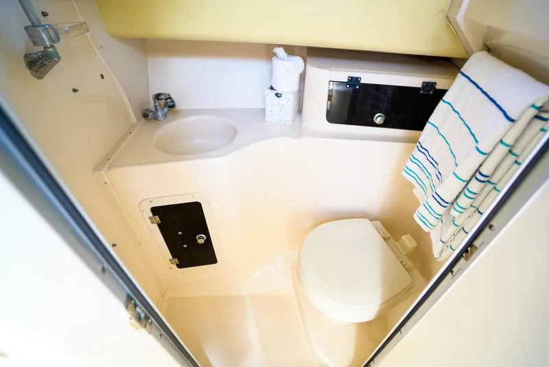 Slide: The Image of 2005 Grady-White Marlin 300 boat bathroom with sink, toilet, and towel rack. - 23