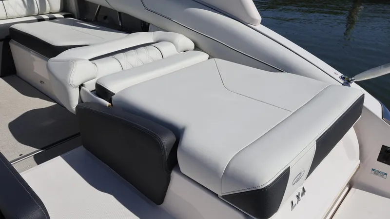 Slide: The Image of 2022 Regal LX4 boat interior with luxurious white and black seating. - 11