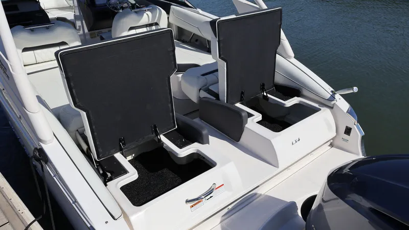 Slide: The Image of 2022 Regal LX4 boat with open storage compartments on the deck. - 12
