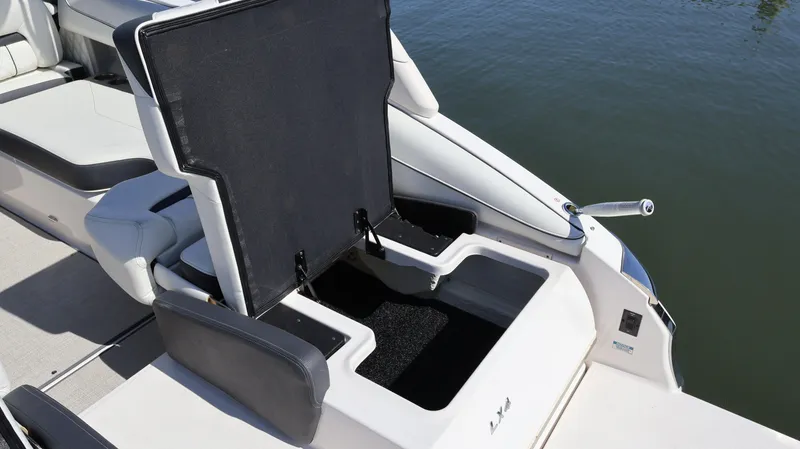 Slide: The Image of 2022 Regal LX4 boat with open storage compartment, showcasing sleek design and functionality. - 13