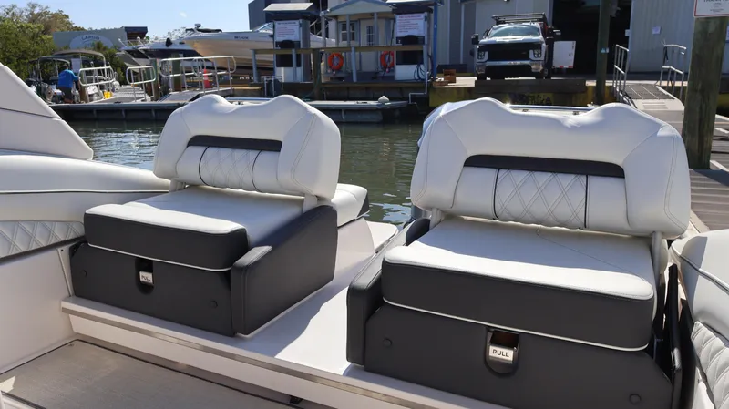 Slide: The Image of Luxury seating on a 2022 Regal LX4 boat at a marina. - 16