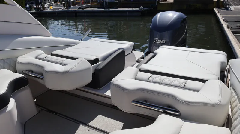 Slide: The Image of 2022 Regal LX4 boat interior with plush seating and powerful outboard motor. - 18