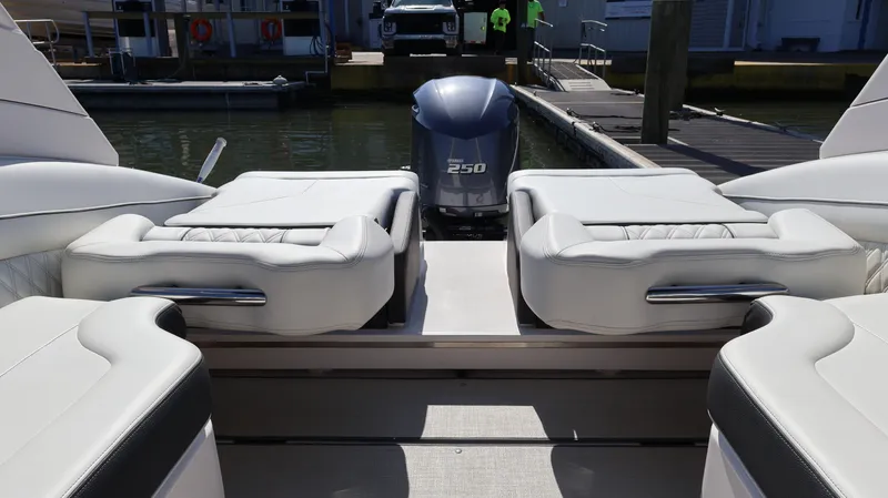 Slide: The Image of 2022 Regal LX4 boat interior with plush seating and powerful 250 engine at dock. - 19