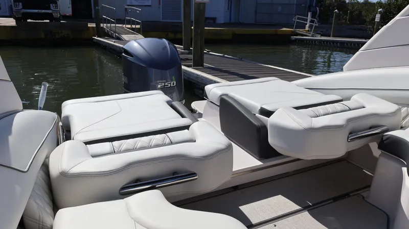 Slide: The Image of 2022 Regal LX4 boat with luxurious white seating and powerful outboard motor. - 21