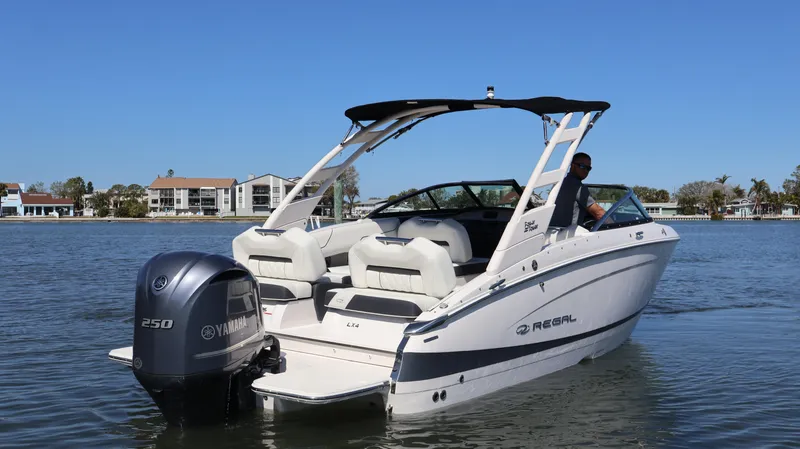 Slide: The Image of 2022 Regal LX4 boat with Yamaha 250 engine on a calm lake. - 3